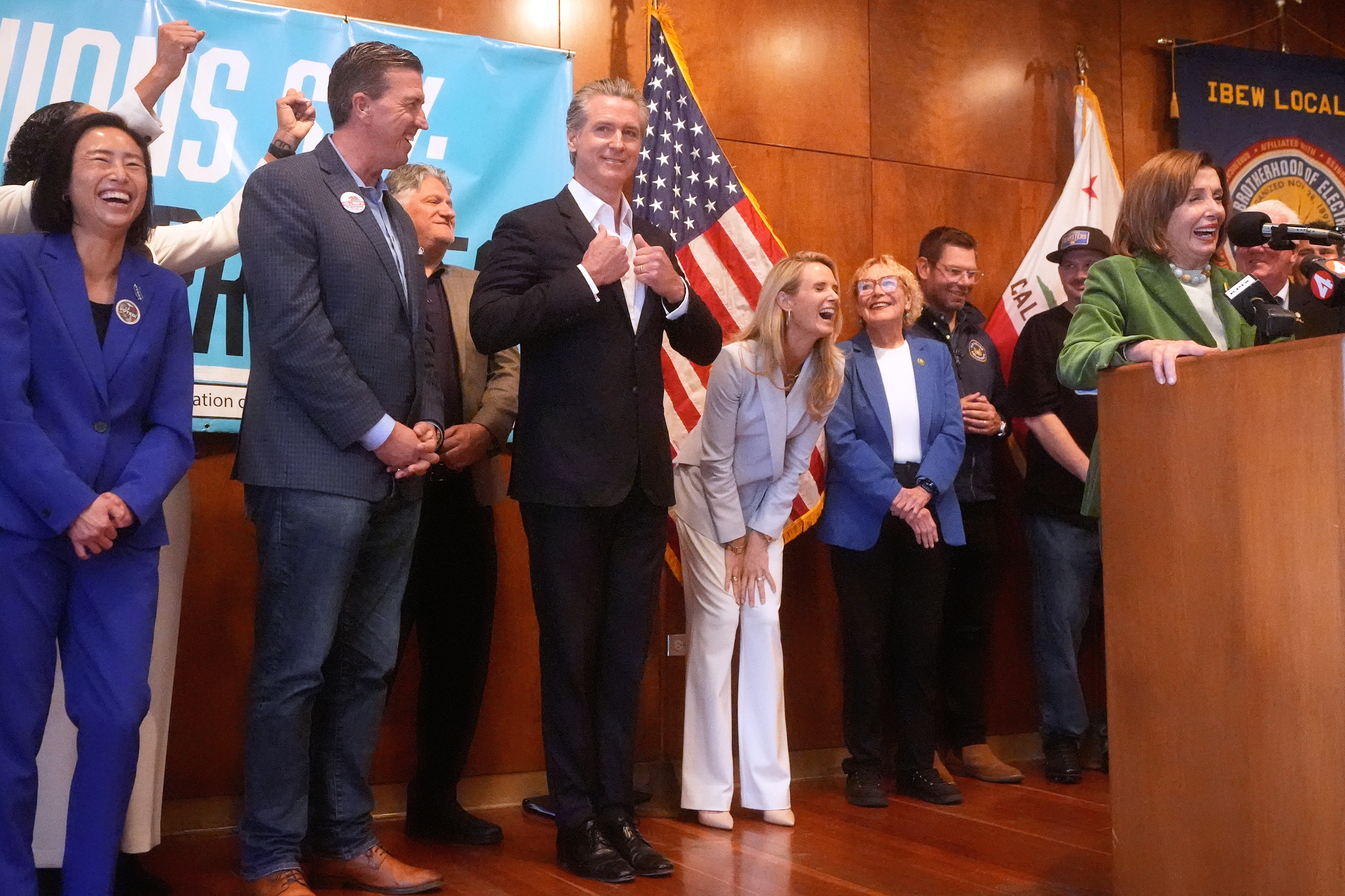 California Gov. Gavin Newsom and his wife, first partner Jennifer Siebel-Newsom, middle right, react as Rep. Nancy Pelosi peaks during a redistricting campaign event in San Francisco on Monday.