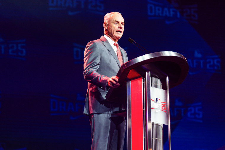 Rob Manfred speaks at a podium on stage